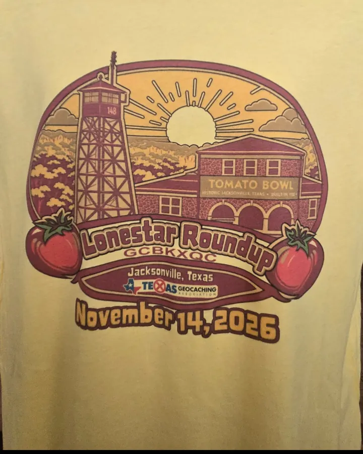 Yellow 2026 Lone Star Roundup T-shirt showing a fire lookout tower, the Tomato Bowl stadium, and tomatoes, with Jacksonville, Texas and November 14, 2026